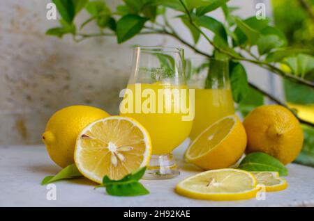 Traditioneller italienischer hausgemachter Zitronenalkohol Likör Limoncello mit Zitronenstücken Stockfoto