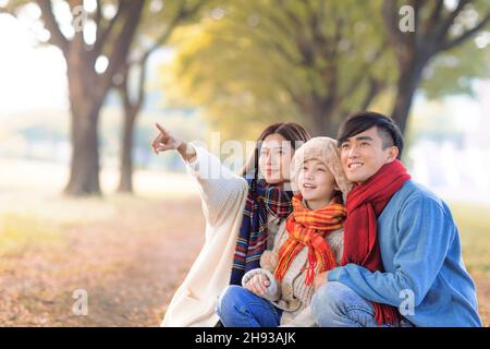 Glückliche asiatische Familie im Herbstpark Stockfoto