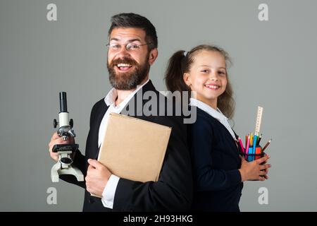 Erstaunt Lehrer mit aufgeregt glücklich Schüler Schulmädchen. Porträt von lustigen Schüler Schülerin und Tutor mit Schulbedarf. Glückliche Lehrerin und Schülerin Stockfoto