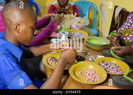 (211204) -- YAOUNDE, 4. Dezember 2021 (Xinhua) -- Junge Blinde werden im Rehabilitationsklub für blinde Jugendliche in Yaounde, Kamerun, am 29. November 2021 in Nähen und Schmuckherstellung mit Perlen ausgebildet. Menschen mit Behinderungen in Kamerun folgen verschiedenen Ausbildungs- und Sozialprogrammen in Institutionen wie der Fachschule für hörgeschädigte Kinder und dem Rehabilitationsklub für blinde Jugendliche, die ihnen helfen, sich wieder in die Gemeinschaft zu integrieren. Es gibt schätzungsweise 3,5 Millionen Menschen mit Behinderungen in Kamerun, und die Regierung war entschlossen, ihr Wohlergehen in der Gesellschaft zu gewährleisten, dem mi des Landes Stockfoto