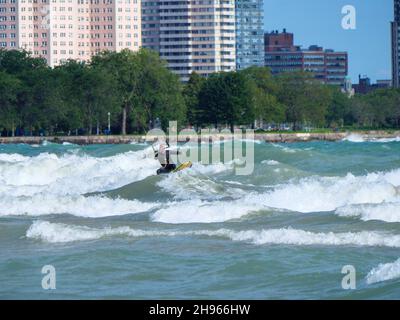 Ein Mann mittleren Alters kitesurft am Montrose Beach in Chicago. Stockfoto
