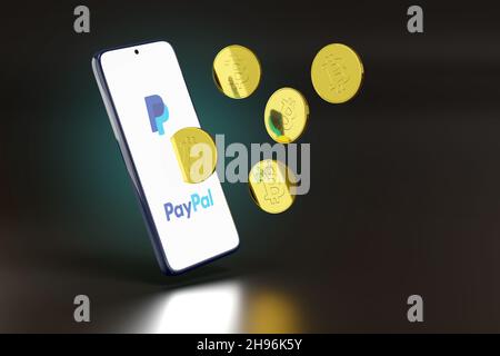 Buenos Aires, Argentinien - 4th. Dezember 2021: Mobiltelefon mit Paypal-Logo und Bitcoins, die aus dem Bildschirm kommen. 3D Abbildung. Stockfoto