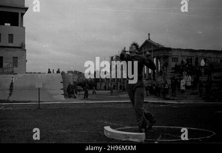 Warszawa, 1947-08-31. Miêdzynarodowe spotkanie lekkoatletyczne Praga-Warszawa na stadionie klubu sportowego Legia. NZ. Konkurencja w pchniêciu kul¹. W ie widoczne ruiny koœcio³a pw. Matki Boskiej Czêstochowskiej przy ul. £azienkowskiej. po/ms PAP Warschau, 31. August 1947. Das Internationale Athletic Meeting (Prag-Warschau) auf dem Stadion des Legia Militärsportvereins. Abgebildet: Der Schuss. Im Hintergrund die Ruinen der Kirche der Heiligen Mutter von Tschenstochau in der Lazienkowska Straße. po/ms PAP Stockfoto