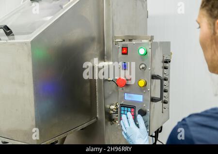 Frau, die in der Industrie arbeitet und Ausrüstung anpasst Stockfoto
