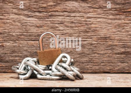 Vorhängeschloss auf einem Stapel Metallkette. Sicherheit, Schutz von Eigentum, symbolische Sicherheit. Stockfoto