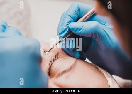 Gesichtsreinigung in der Kosmetologie mit Hilfe eines Löffels uno, mechanische Gesichtsreinigung, Olton-Produkte. Stockfoto