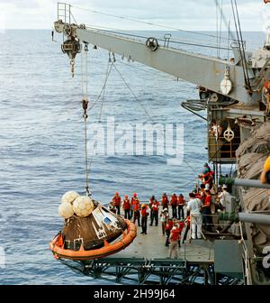 Crewmänner an Bord der USS Iwo Jima, das erste Berwertungsschiff für die Apollo 13-Mission, heben das Command Module (CM) an Bord des Schiffes. Die Apollo 13 Crew-Männer, die Astronauten James A. Lovell Jr., John L. Swigert Jr. und Fred W. Haise Jr., waren bereits an Bord der Iwo Jima, als dieses Foto aufgenommen wurde. Die CM, mit den drei müden Besatzungsmitgliedern an Bord, spritzte am 17. April 1970 um 12:07:44 Uhr (CST) nieder, nur etwa vier Meilen von dem Bergungsschiff im Südpazifik entfernt. Stockfoto