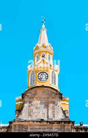 Die Puerta del Reloj, Torre del Reloj oder Boca del Puente (Uhrturm-Denkmal) atemberaubend und leuchtend gelb in Cartagena, Kolumbien an einem Sommertag. Stockfoto