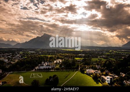 Kirche zur Schmerzhaften Gottesmutter und Panoramablick auf den Süden Salzburgs bei abstrakten Lichtverhältnissen Stockfoto