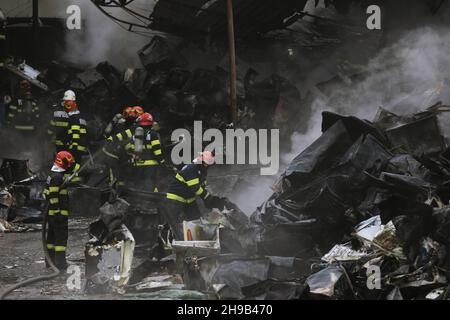 Bukarest, Rumänien - 5. Dezember 2021: Rumänische Feuerwehrleute versuchen, einen Brand zu löschen, der in einem Recyclingzentrum ausbrach. Stockfoto