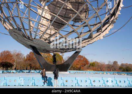 An einem späten Herbstnachmittag macht eine Fotografin Fotos von ihrem Freund, Kunden, Ehemann oder einer bedeutenden anderen Person. In einem Park in Queens, New York. Stockfoto