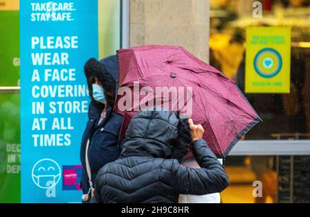 Preston, Lancashire. Uk Wetter 6 Dez 2021. Geschäfte, Einkäufer, Einkaufen im Stadtzentrum an einem nassen und windigen Tag. Eine Wetterwarnung für 50mph Winde wird in Kraft treten, wenn sich der Sturm Barra nähert. Quelle: MediaWorldImages/AlamyLiveNews Stockfoto