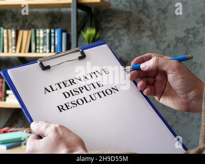 Man liest über alternative Streitbeilegung ADR. Stockfoto