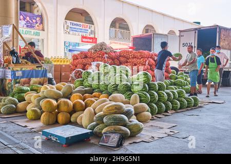 Frische Wassermelone, Torpedo-Melonen, die von einem LKW entladen werden. Mirabad Bazaar, Mirobod Bozori in Taschkent, Usbekistan. Stockfoto