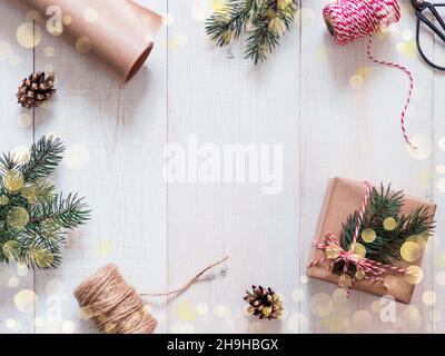 Weihnachten Geschenk Verpackung Hintergrund, kopieren Raum. Geschenkverpackung ohne Verschwendung. Bastelpapier und Bokeh-Lichter. Winterurlaub Konzept, Flat Lay oder Draufsicht. Stockfoto