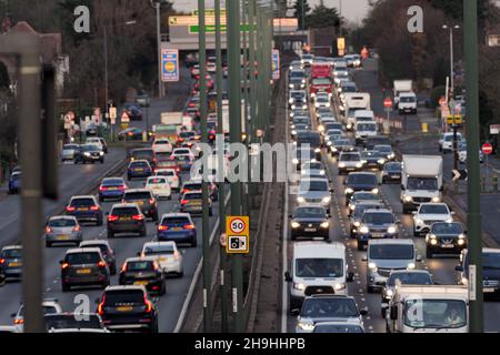 Starker Pendlerverkehr am frühen Abend mit Autoscheinwerfern auf der A3 Trunk Road in der Abenddämmerung im Südwesten Londons. Stockfoto