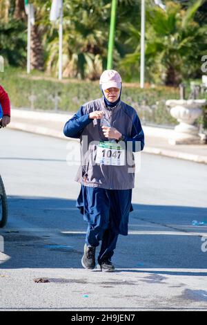 El Madher, Batna, Algerien - 12-04-2021: Muslimische Frau, die an der Ausgabe 11th des Madghacen International Marathon teilnimmt Stockfoto