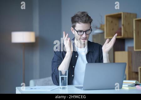 Der selbstbewusste Teamleiter eines europäischen Geschäftsmannes führt Online-Videokonferenzen auf einem Laptop durch Stockfoto