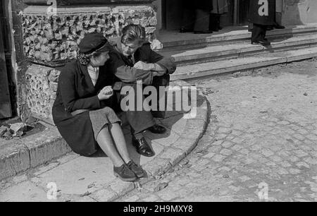 Warszawa, 1948-10-04. Rozpoczêcie roku akademickiego studentów Politechniki Warszawskiej. Czynne s¹ ju¿ wszystkie wydzia³y, uczy siê 5 tys. studentów. W tym roku przyjêto Ponad tysi¹c osób, czêœæ z nich to kursanci Batalionu Akademickiergo. NZ. Para studentów przed wejœciem do Gmachu G³ównego. mw PAP Warschau, 4. Oktober 1948. Die Eröffnung des Studentenjahres an der Technischen Universität Warschau. Geöffnet sind alle Abteilungen mit 5.000 Studenten eingeschrieben. In diesem Jahr wurden mehr als 1.000 Menschen zugelassen. Im Bild: Ein Studentenpaar vor dem Hauptgebäude. mw PAP Stockfoto