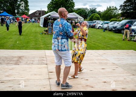 Einheimische tanzen und lachen im Nutley Village Fete, Nutley, East Sussex, Großbritannien. Stockfoto