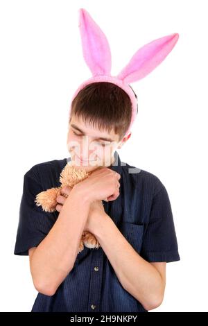 Teenager mit Hasenohren und Teddybär isoliert auf dem weißen Hintergrund Stockfoto