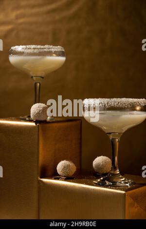 Festliche Getränke. Weiße Coco Cocktails Gläser auf goldenem Hintergrund. Konzept der Feier Stockfoto