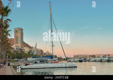 Blick auf die abenteuerliche Yacht, Boote, Segelboote, die Festung auf dem Hügel, Wolkenkratzer des Hotels el Sol und die Melia Alicante im Hintergrund Stockfoto