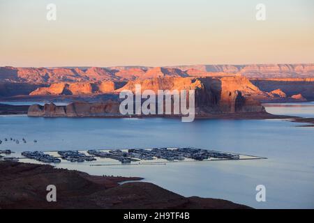 Glen Canyon National Recreation Area, Page, Arizona, USA. Blick über den Jachthafen von Wahweap auf die hohen schroffen Klippen von Castle Rock und Romana Mesa, Sonnenuntergang. Stockfoto