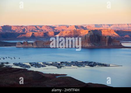 Glen Canyon National Recreation Area, Page, Arizona, USA. Blick über den Jachthafen von Wahweap auf die hohen schroffen Klippen von Castle Rock und Romana Mesa, Sonnenuntergang. Stockfoto