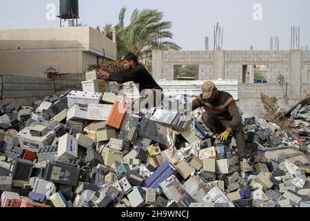 Gaza. 8th Dez 2021. Am 8. Dezember 2021 sammeln Arbeiter beschädigte Batterien in der Stadt Khan Younis im südlichen Gazastreifen. Über 25.000 gebrochene Bleiakkus stecken im Gazastreifen fest und stellen eine ernste Bedrohung für die Umwelt und das Leben der Palästinenser dar. UM MIT dem Feature zu GEHEN: Die Überlagerung von ausrangierten Bleisäurebatterien bedroht die Umwelt, das Leben der Bewohner des Gazastreifens. Quelle: Rizek Abdeljawad/Xinhua/Alamy Live News Stockfoto