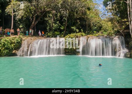 SIQUIJOR, PHILIPPINEN - 9. FEBRUAR 2018: Die Menschen genießen die Cambugahay Falls auf der Insel Siquijor, Philippinen. Stockfoto