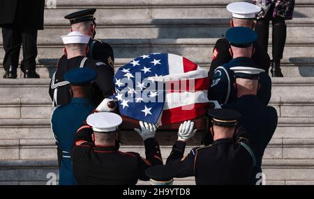 Washington, DC, USA. 09th Dez 2021. Ein militärischer Ehrengarde der gemeinsamen Dienste trägt die Schatulle mit den Überresten des verstorbenen Senators Robert Dole (R-KS) am 09. Dezember 2021 in Washington, DC, die Stufen des US-Kapitols hinauf. Der ehemalige Mehrheitsführer des Senats und Kandidat des republikanischen Präsidenten wird den ganzen Tag vor seiner Beerdigung in der National Cathedral in der Rotunde des Kapitols liegen. Kredit: Anna Moneymaker/Pool Via Cnp/Media Punch/Alamy Live News Stockfoto