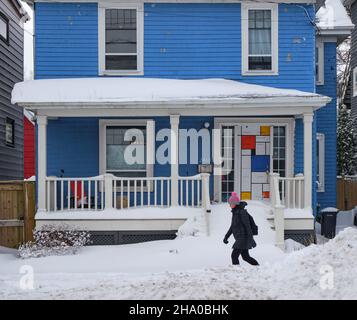 Halifax, Kanada, bedeckt mit Schnee nach dem ersten Schneesturm der Saison. Fußgänger zu Fuß durch Haus mit Mondrian Design Tür Stockfoto