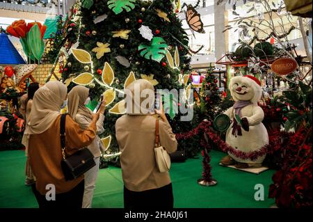 Kuala Lumpur, Malaysia. 09th Dez 2021. Als Vorsichtsmaßnahme gegen die Verbreitung von Covid-19 sahen Käufer, die Gesichtsmasken trugen, Fotos von der Weihnachtsdekoration in einem Einkaufszentrum in Kuala Lumpur machen. Kredit: SOPA Images Limited/Alamy Live Nachrichten Stockfoto