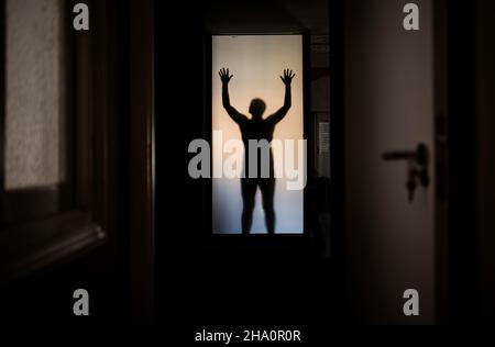 Schatten des Menschen hinter Glas Stockfoto