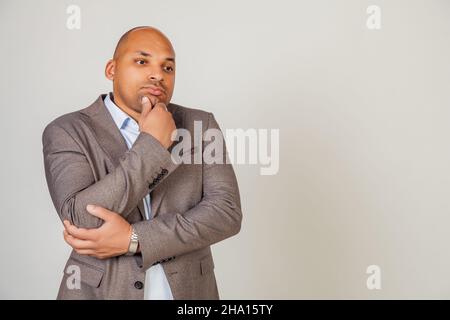 Ernsthaft nachdenklich besorgt afrikanischen Mann männlich, berühren Kinn, Blick zur Seite, denken über Lösung für Inspiration, in Gedanken verloren, träumen Stockfoto