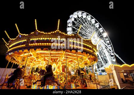 Das Karussell und das große Rad vor dem Schlossgelände. Der Markt, der nach einer Annullierung im Vorjahr aufgrund von Covid 19 zurückkehrt, ist einer der größten Weihnachtsmärkte in Europa. Im Zentrum des Catle und der Kathedrale im Bailgate-Viertel von Lincoln und Umgebung ziehen die Märkte Besucher aus ganz Europa an. Stockfoto