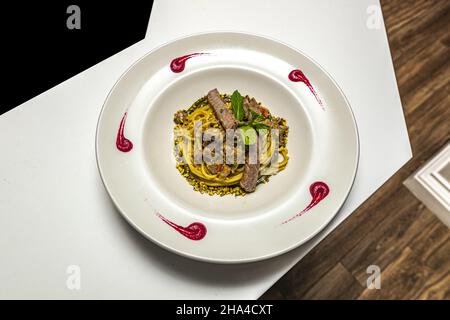 Blick von oben auf leckere Spaghetti mit Meeresfrüchten, Tuna-Pasta auf einem weißen Teller Stockfoto