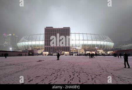 KIEW, UKRAINE - 23. NOVEMBER 2021: Nachtansicht von der Fassade des NSC Olimpiyskyi-Stadions in Kiew vor dem UEFA Champions League-Spiel Dynamo Kiew gegen Bayern München Stockfoto