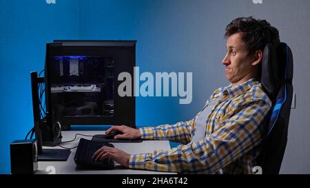 Süchtig nach Spielen spielt Mann ständig am Computer sitzen Stockfoto