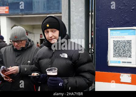 Fans neben einem NHS Covid-19 Check-in-Schild vor dem Sky Bet Championship-Spiel in der Kenilworth Road, Luton. Bilddatum: Samstag, 11. Dezember 2021. Stockfoto