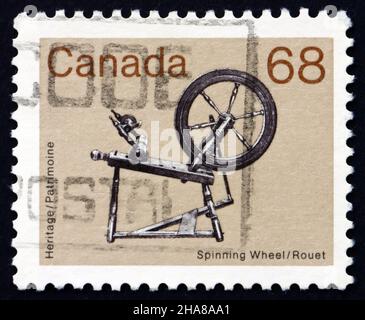 Kanada - ca. 1985: eine Briefmarke gedruckt in Kanada zeigt Spinnrad, Erbe, ca. 1985 Stockfoto