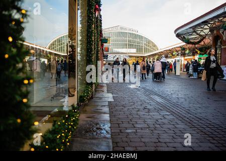 Windsor, Großbritannien. 12th. Dezember 2021. Im Stadtzentrum passieren die Menschen Geschäfte mit weihnachtlichen Schaufenstern. Laut dem Office of National Statistics (ONS) geben britische Haushalte mehr für Waren und weniger für Dienstleistungen aus, während sich die Omicron-Coronavirus-Variante ausbreitet. Kredit: Mark Kerrison/Alamy Live Nachrichten Stockfoto