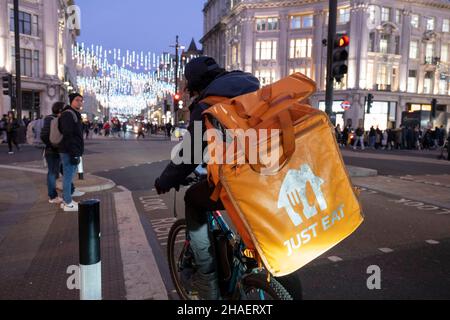 Essen Sie einfach am 22nd. November 2021 in London, Großbritannien, einen zum Mitnehmen lieferten Radfahrer auf der Oxford Street. Just Eat Limited ist ein britischer Online-Service für Lebensmittelbestellung und -Lieferung, der 2001 gegründet wurde. Sie fungiert als Vermittler zwischen unabhängigen Imbissbuden und Kunden, wobei Tausende von Fahrradkurierern Lebensmittel per Fahrrad und andere Transportmittel liefern. Gig-Mitarbeiter sind unabhängige Auftragnehmer, Online-Plattformmitarbeiter, Vertragsarbeiter, Bereitstellte und Zeitarbeiter. Gig-Mitarbeiter schließen formelle Vereinbarungen mit On-Demand-Unternehmen, um Dienstleistungen für die Kunden des Unternehmens zu erbringen. Stockfoto