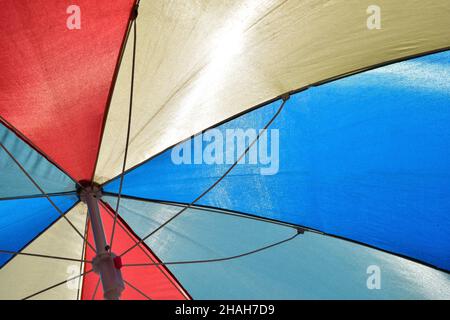 Bunt gestreifter Sonnenschirm von unten im Vollformat fotografiert Stockfoto