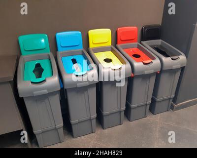 Fünf bunte Behälter zum Sammeln und Sortieren verschiedener Abfallarten zum Recycling Stockfoto