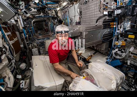ISS - 07. Dezember 2021 - NASA-Astronaut und Expedition 66 Flugingenieur Mark Vande Hei packt Hardware aus, um den Flow Boiling Condensation Exp Stockfoto