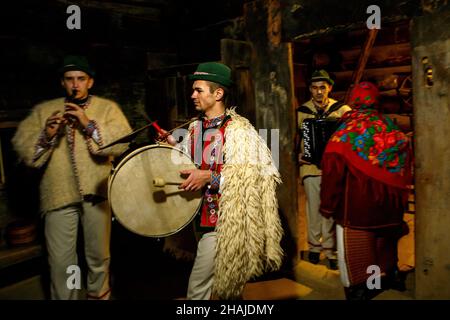 USCHHOROD, UKRAINE - 10. DEZEMBER 2021 - Menschen in traditionellen ukrainischen Kostümen führen die Rituale während der Andriivski-Vecchornytsi-Feier aus Stockfoto