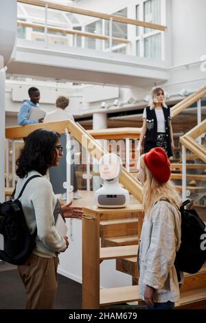 Studenten, die Sprachassistenten in der Bibliothek verwenden Stockfoto