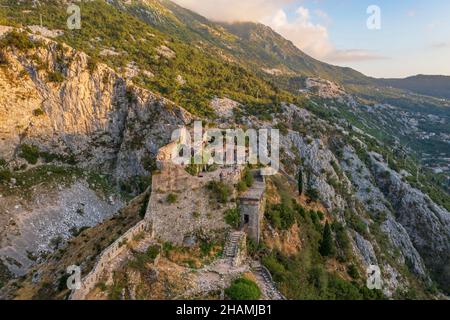 Blick auf den Sonnenuntergang auf der Spitze der St. John (San Giovanni) Festung und Burg, Altstadt, Kotor, Bucht von Kotor, Montenegro. Stockfoto